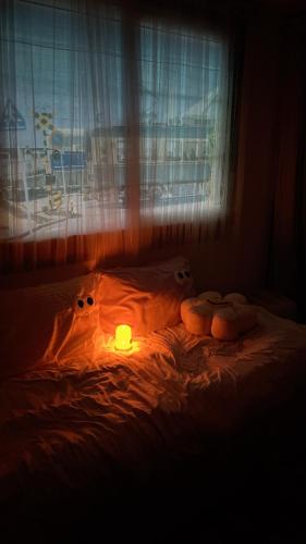 a room with a bed with a candle on it at Tiny house in Ulsan