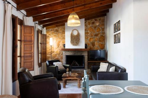 a living room with couches and a fireplace at La Granja de Antonio in Alhaurín el Grande