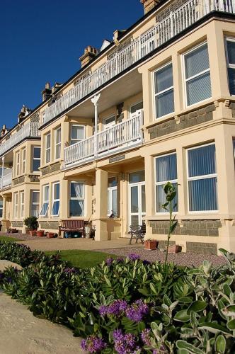 a large building with a balcony on top of it at Trem Y Mor - Edge of the Sea in Tywyn