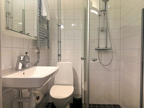 a bathroom with a sink and a toilet and a shower at Stay Inn Apartment Sveavägen in Stockholm