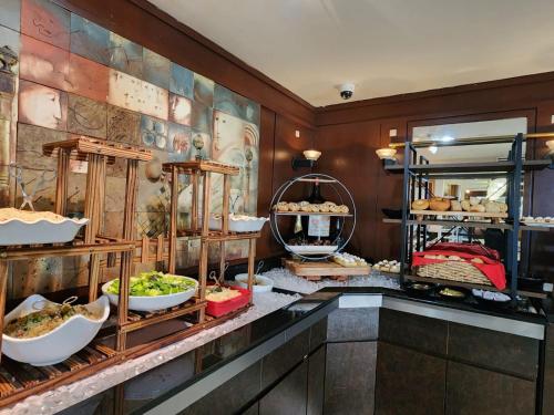a buffet line with bowls of food on display at Mayaguez Resort & Casino in Mayaguez