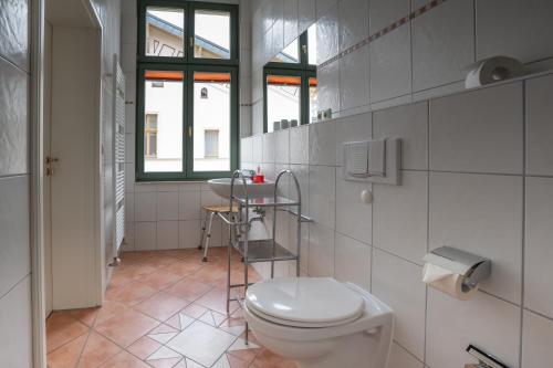 a bathroom with a toilet and a sink at Villa Stock Studio in Heringsdorf