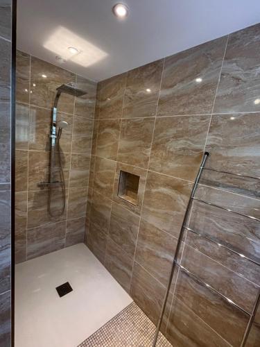 a bathroom with a shower with a glass door at Can Cando in Thuir