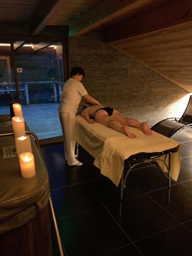 a man is laying on a bed in a room at La Ferme du Douanier & Spa 5 étoiles ALL INCLUSIVE in Ventron