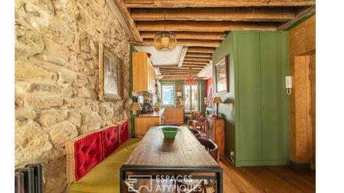 a room with a table and a stone wall at Paris Best view w/Rooftop! in Paris