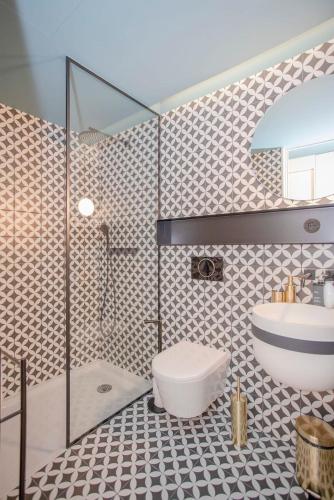 a bathroom with a shower and a toilet and a sink at Liiiving in Porto - Ribeira Design Apartment in Porto