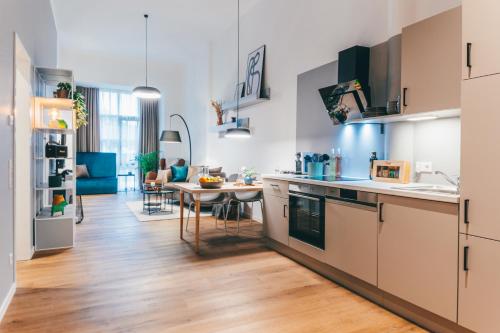 a kitchen with a table and a dining room at LIVELY Weiße Dame Gronau in Gronau