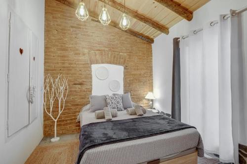 a bedroom with a large bed in a brick wall at Casa da Travessa - Lago do Alqueva in São Marcos do Campo