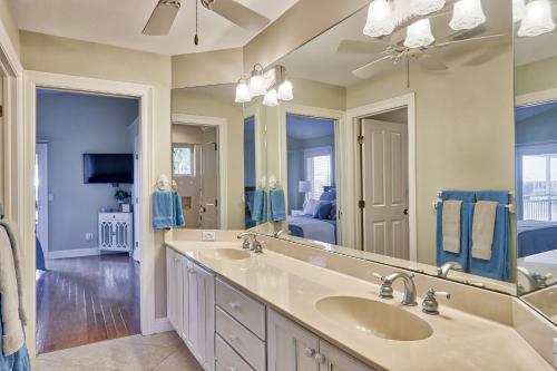 a bathroom with two sinks and a large mirror at Eagle's View in Sanibel