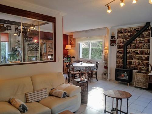 una sala de estar con un sofá y una mesa en Ty Clafout Vannetaise parking wifi linge non inclus, en Saint-Nolff