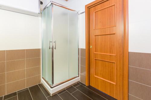 a shower with a wooden door in a bathroom at Casa Vacanze Baglivo in Casigliano