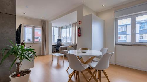 a living room with a white table and chairs at Sunny Horizon Retreat by LovelyStay in Paço de Arcos