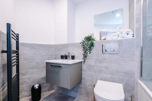 La salle de bains est pourvue de toilettes et d'un lavabo. dans l'établissement Icona 2 Apartment, With Free Onsite Gym and Secure Parking, à York