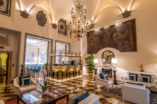a living room with a chandelier and a table at Golden Tower Hotel & Spa in Florence