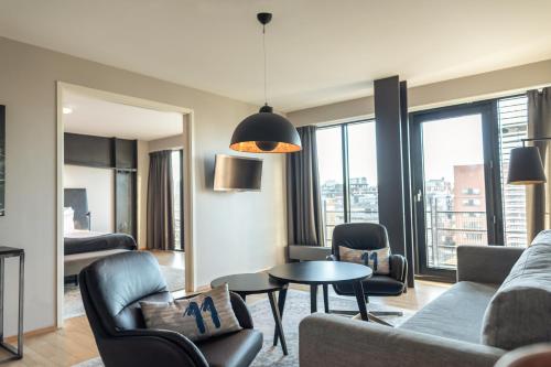 a living room with a couch and chairs and a table at Quality Hotel 11 & Eriksbergshallen in Gothenburg
