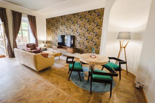 a living room with a table and a couch at Opera apartments in Banská Štiavnica