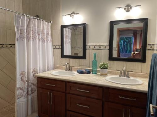 a bathroom with two sinks and a shower at Casa Maya in West Bay