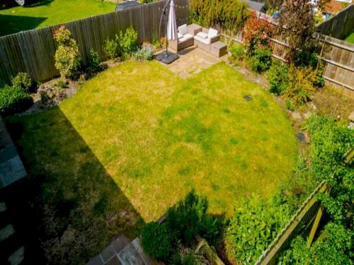 an aerial view of a garden with a large lawn at Pass the Keys Bright Spacious Chilterns Hideaway in Saunderton