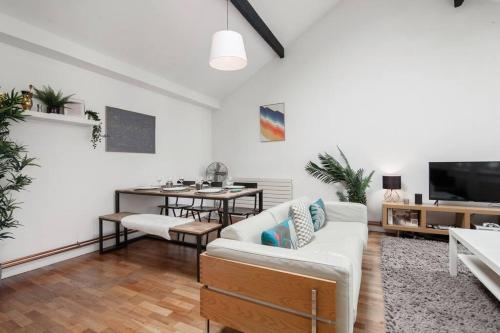 a living room with a couch and a table at City Superhost - Northern Quarter Loft Conversion in Manchester