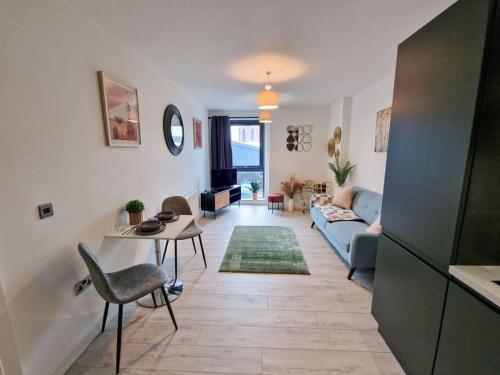 a living room with a couch and a table at Liverpool Baltic Flat in Liverpool