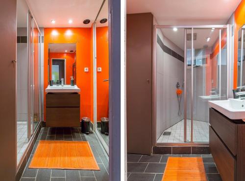 La salle de bains orange est pourvue d'une douche et d'un lavabo. dans l'établissement Hamac Suites - Suite Albon Saint Antoine - 4pers, à Lyon