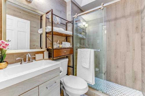 a bathroom with a toilet and a glass shower at Stylish 2Bd in Brooklyn Heights in Brooklyn