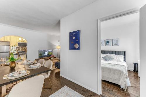a bedroom with a bed and a table with chairs at Stylish 2Bd in Brooklyn Heights in Brooklyn