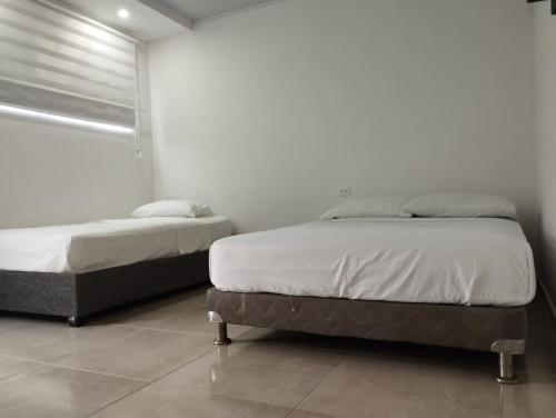 Postel nebo postele na pokoji v ubytování Hostal Casa Marle