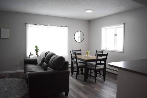 a living room with a couch and a table with chairs at Arctic 415 in Grand Rapids