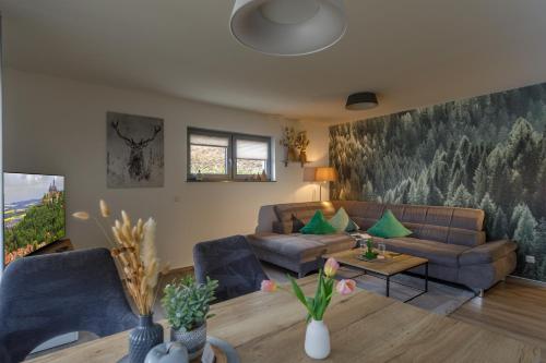 a living room with a couch and a table at Lindenberg Apartments in Wernigerode