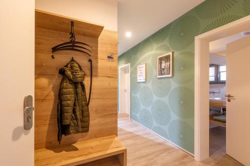 a hallway with a statue of a leather jacket on the wall at Lindenberg Apartments in Wernigerode