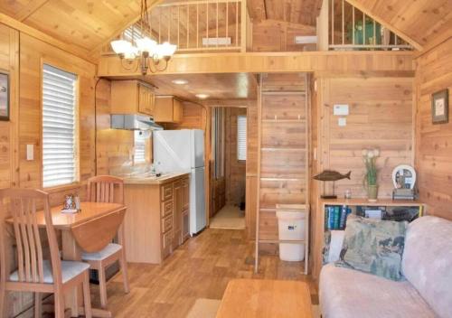a kitchen and living room in a tiny house at Cozy 1BR Cabin in Jacksonville in Jacksonville