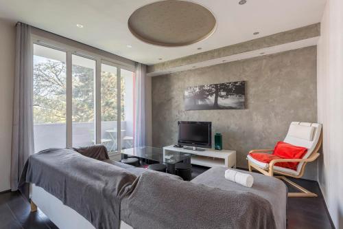 Sala de estar con 2 camas y TV en Hamac Suites - Simon Jallade - 4 people en Sainte-Foy-lès-Lyon