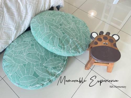 a toy animal sitting next to two plates on the floor at GreeneryHome 1-4pax Trefoil Studio Setia Alam in Shah Alam