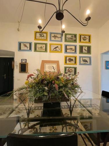 a glass table with a bouquet of flowers in a room at Casa nonna Mimma in Narni
