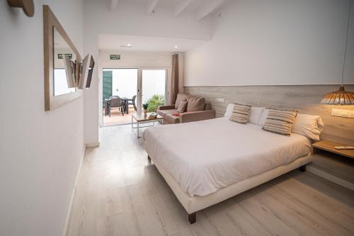 a bedroom with a bed and a living room at Xubec - Albergue Juvenil in Ciutadella