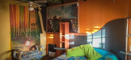 a room with a chair and a painting on the wall at Cabañas Arenas del Faro in Mar del Plata