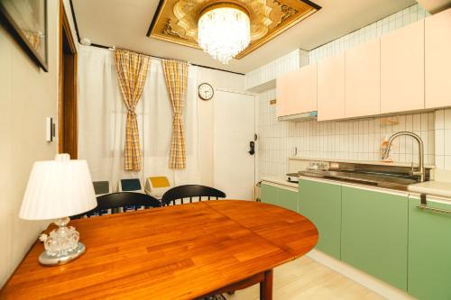 a kitchen with a wooden table with a lamp on it at Oak&Co in Seoul