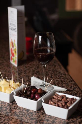 a glass of wine and a bunch of different types of food at Ibis Marrakech Palmeraie in Marrakech
