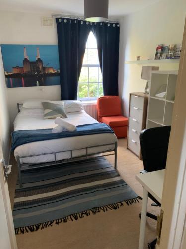 a bedroom with a bed and a window at CENTRAL LOCATION! Double Bedroom 2 Mins Walk from Battersea Power underground Station! in London