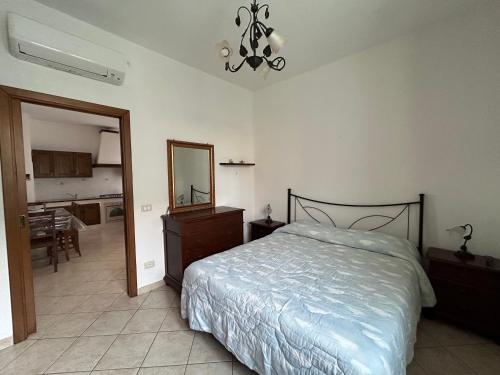 a bedroom with a bed and a dresser and a mirror at Appartamento Deluxe I Cigni - Forio Ischia in Forio d'Ischia