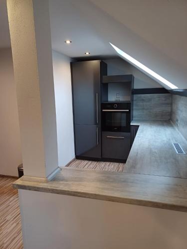 a kitchen with a black refrigerator and a stove at MARLEN in Ústí nad Labem