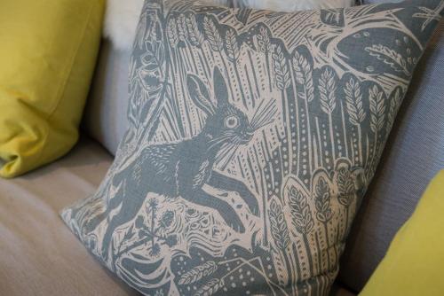 a black and white pillow with a rabbit on it at Stalker's Lodge in Perth