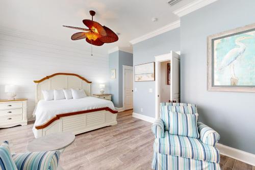 a bedroom with a bed and a table and chairs at Panhandle Luxury Beach House in Panama City Beach