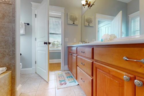 a bathroom with a sink and a shower at Panhandle Luxury Beach House in Panama City Beach