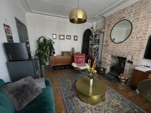 a living room with a couch and a fireplace at Town House in the North Laines in Brighton & Hove