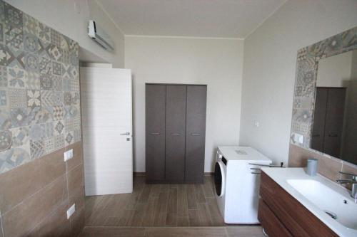 a bathroom with a sink and a washing machine at La Valle B&B in Castel Campagnano