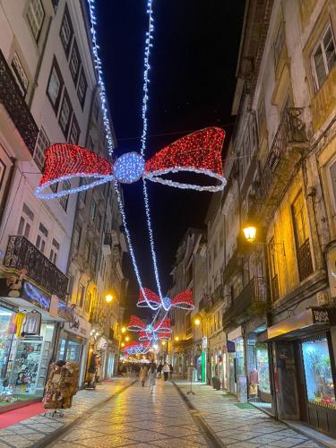 a street with christmas lights in a city at night at Unique Experience in Coimbra