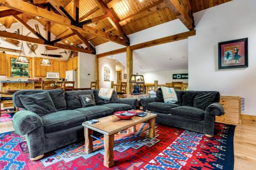 a living room with two couches and a table at 3137 Arrowhead in Teton Village