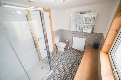 a bathroom with a shower and a toilet at Oran na Cuthaig in Lochs